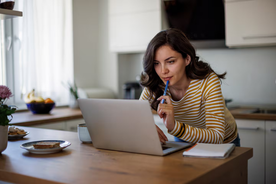 women at her laptop researching