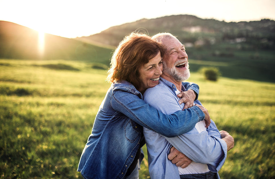 Older couple hugging outside